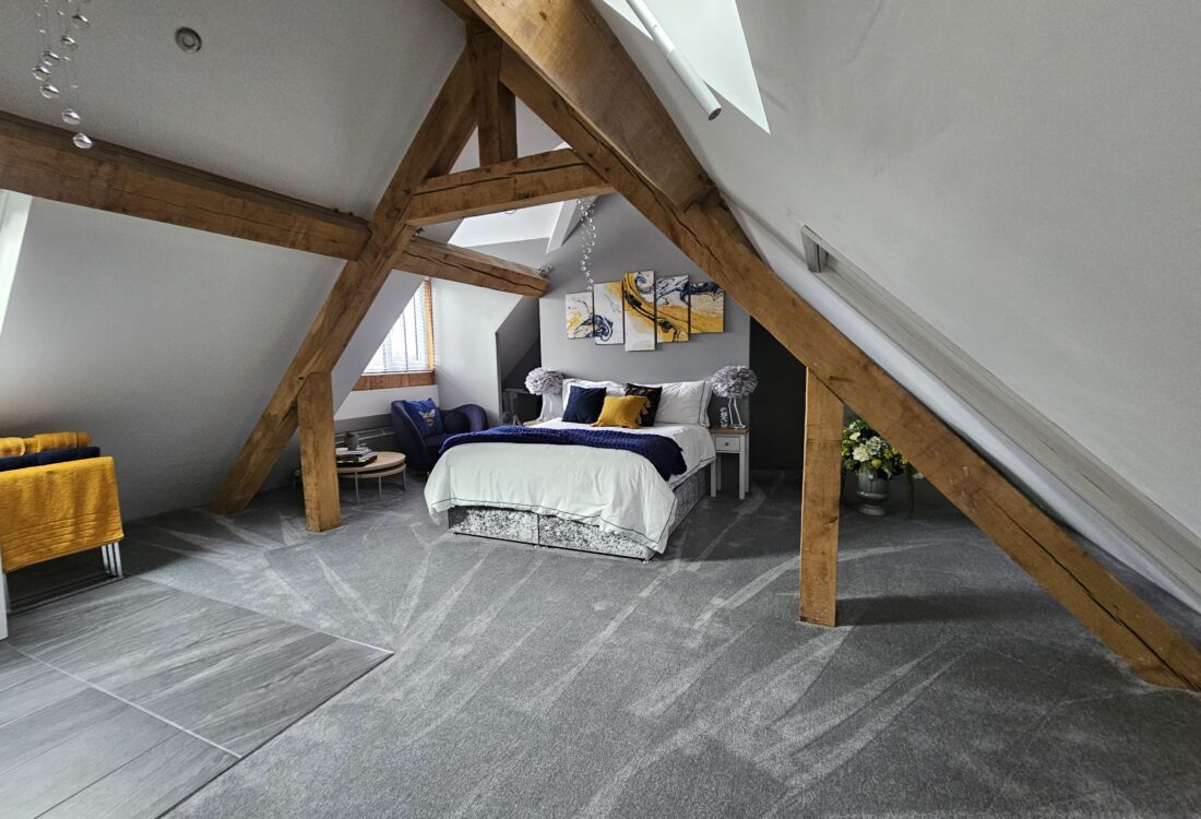modern bedroom with oak framed ceiling