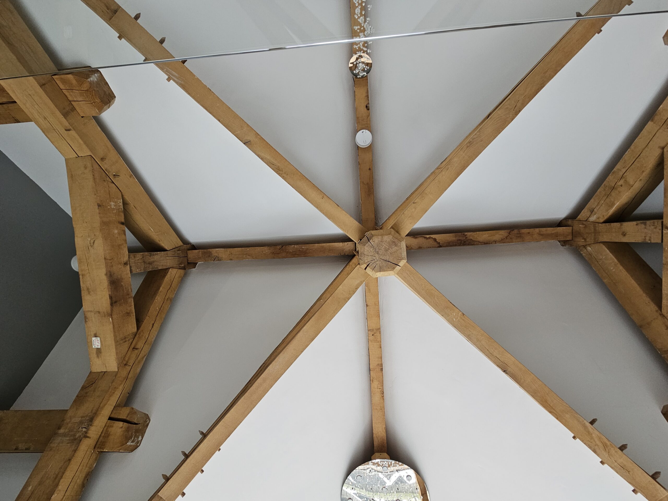 Oak cruciform truss above a vaulted atrium